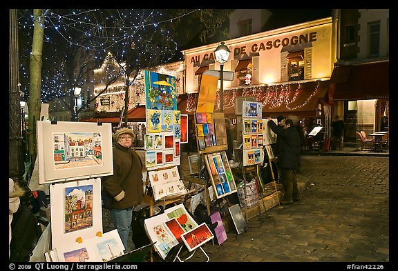 Art for sale on Place du Tertre at night, Montmartre. Paris, France