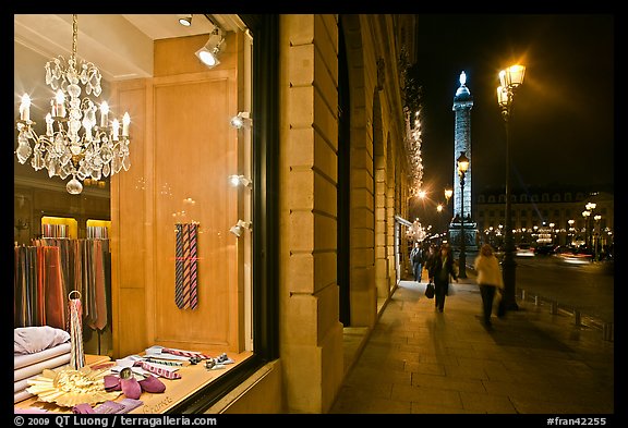 Luxury storefront and Place Vendome column by night. Paris, France