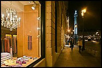 Luxury storefront and Place Vendome column by night. Paris, France