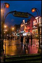 Art deco subway entrance and Moulin Rouge by night. Paris, France ( color)