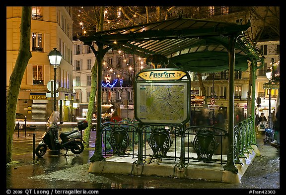 Subway entrance with art deco canopy by night. Paris, France (color)