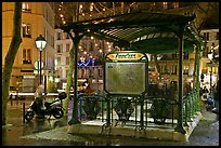 Subway entrance with art deco canopy by night. Paris, France (color)