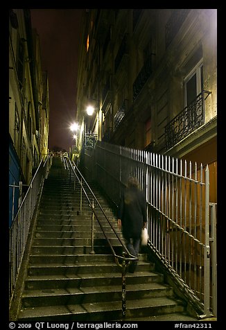 Woman climbing steep steps to the Butte, Montmartre. Paris, France