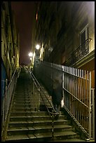 Woman climbing steep steps to the Butte, Montmartre. Paris, France