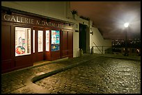 Gallery, street light, and coblestone pavement, Montmartre. Paris, France