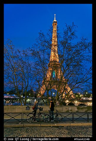 Bicyclists and Eiffel tower at night. Paris, France (color)