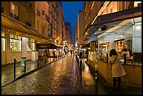 Woman buying food on street at night. Quartier Latin, Paris, France (color)