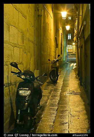 Motorcycles parked in narrow alley at night. Quartier Latin, Paris, France (color)