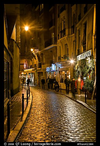 Cobblestone street with restaurants by night. Quartier Latin, Paris, France (color)