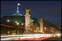 Petit Palais and trafic across Alexandre III bridge by night. Paris, France