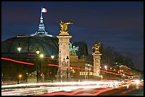 Petit Palais and trafic across Alexandre III bridge by night. Paris, France (color)