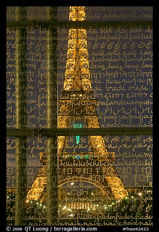 Illuminated Eiffel Tower seen through peace memorial. Paris, France