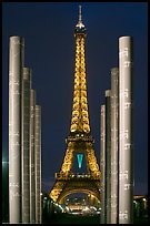 Columns of memorial to peace end Eiffel Tower by night. Paris, France (color)