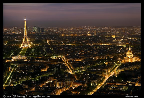 Aerial view at night with Eiffel Tower, Invalides, and Arc de Triomphe. Paris, France