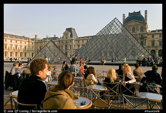 Cafe terrace in the Louvre main courtyard with glass pyramid. Paris, France