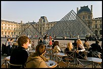 Cafe terrace in the Louvre main courtyard with glass pyramid. Paris, France