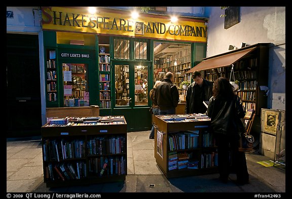 People reading in front of bookstore at night. Quartier Latin, Paris, France (color)