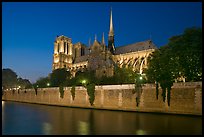 Side view of Notre Dame across Seine River at dusk. Paris, France (color)