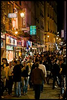 Busy pedestrian street at night. Quartier Latin, Paris, France