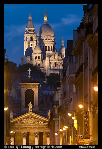 Church of Notre-Dame-de-Lorette with the Basilica of the Sacre Coeur behind at night. Paris, France