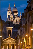 Church of Notre-Dame-de-Lorette with the Basilica of the Sacre Coeur behind at night. Paris, France (color)