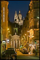 Street, Notre-Dame-de-Lorette, and Sacre Coeur at night. Paris, France (color)