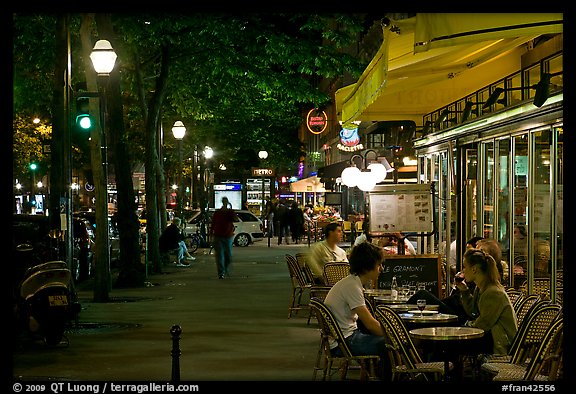 Outdoor cafe terrace on the Grands Boulevards at night. Paris, France (color)