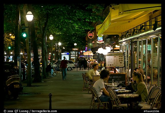 Outdoor cafe terrace on the Grands Boulevards at night. Paris, France