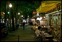 Outdoor cafe terrace on the Grands Boulevards at night. Paris, France (color)