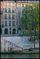 Quay and riverfront buildings on banks of the Seine. Paris, France