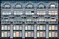 Glass windows of the Samaritaine reflecting colors of sunset. Paris, France