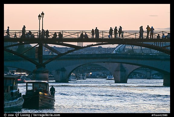 Seine river and people silhouettes on Pont des Arts. Paris, France (color)