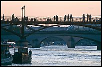 Seine river and people silhouettes on Pont des Arts. Paris, France (color)