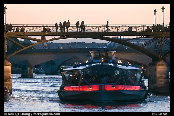 Tour boat below Pont des Arts at sunset. Paris, France (color)