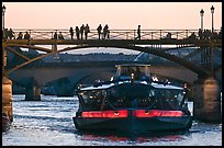 Tour boat below Pont des Arts at sunset. Paris, France (color)