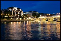 Pont Neuf and Samaritaine reflected in Seine River at night. Paris, France (color)