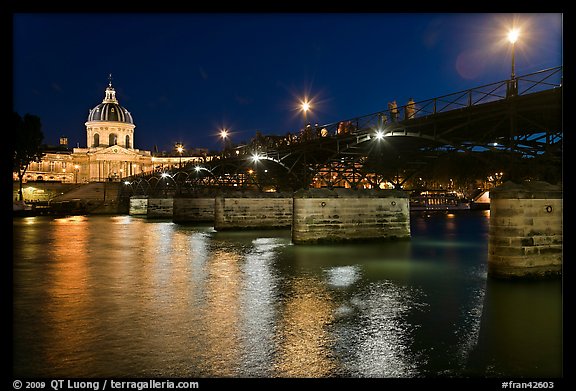 Institut de France, Pont des Arts and Seine reflections at night. Paris, France