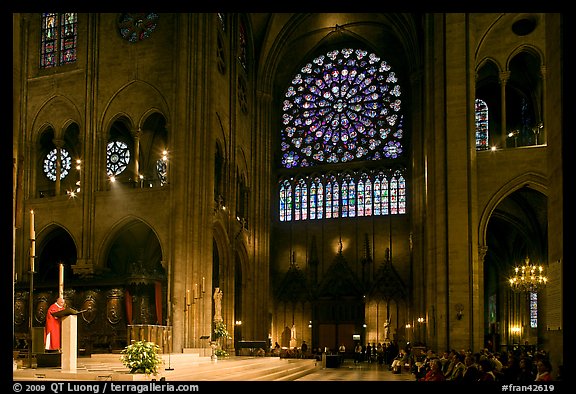 Bishop celebrating mass, South transept, and stained glass rose. Paris, France