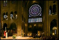 Bishop celebrating mass, South transept, and stained glass rose. Paris, France