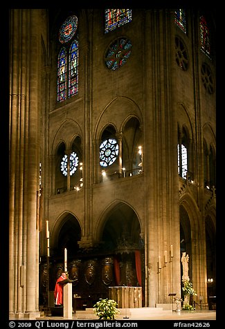 Cardinal reading and choir of Notre-Dame cathedral. Paris, France