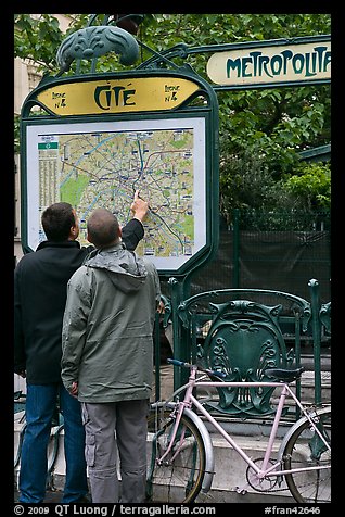 Men looking at a map of the Metro outside Cite station. Paris, France