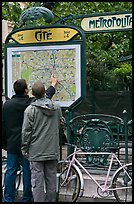 Men looking at a map of the Metro outside Cite station. Paris, France (color)