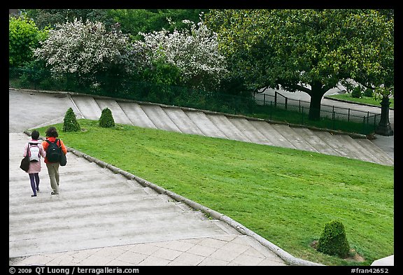 Couple walking down steps in park, Montmartre. Paris, France (color)