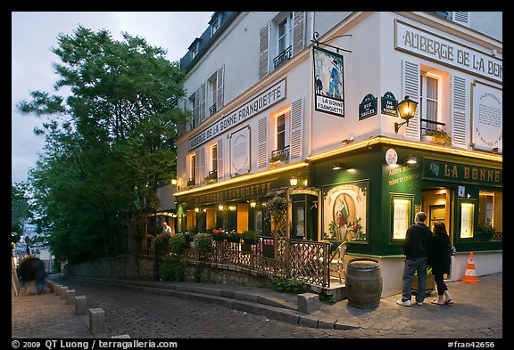 Couple looking at menu outside restaurant, Montmartre. Paris, France (color)