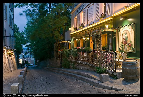 Cobblestone street and restaurant at dusk, Montmartre. Paris, France (color)