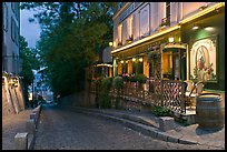 Cobblestone street and restaurant at dusk, Montmartre. Paris, France