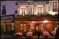 Restaurant and waiter at night, Montmartre. Paris, France