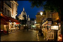 Place du Tertre at night with restaurants and Basilique du Sacre-Coeur, Montmartre. Paris, France