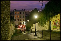 Hillside stairs of butte Montmartre and street lights at sunset. Paris, France (color)