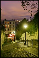 Hillside stairs, street lights, and Eiffel Tower in the distance, Montmartre. Paris, France ( color)
